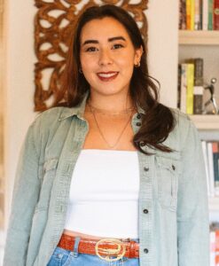 Tara Skipton smiles in front of a bookcase